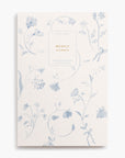 Cottagecore aesthetic book-bound planner notebook with monthly and weekly calendar, project timelines, goal tracking. Cover art style is floral pattern, toile, dutch, blue, delft, ribbon bows, wildflowers.